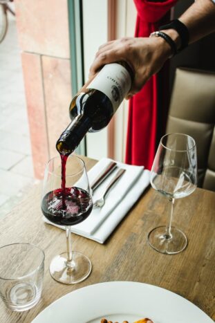 Pouring red wine into glass